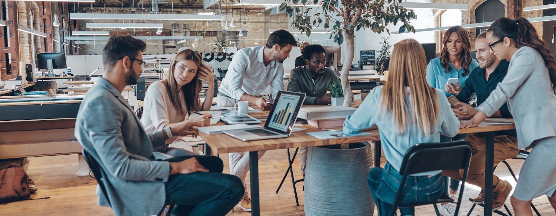 a group of people working together in an office