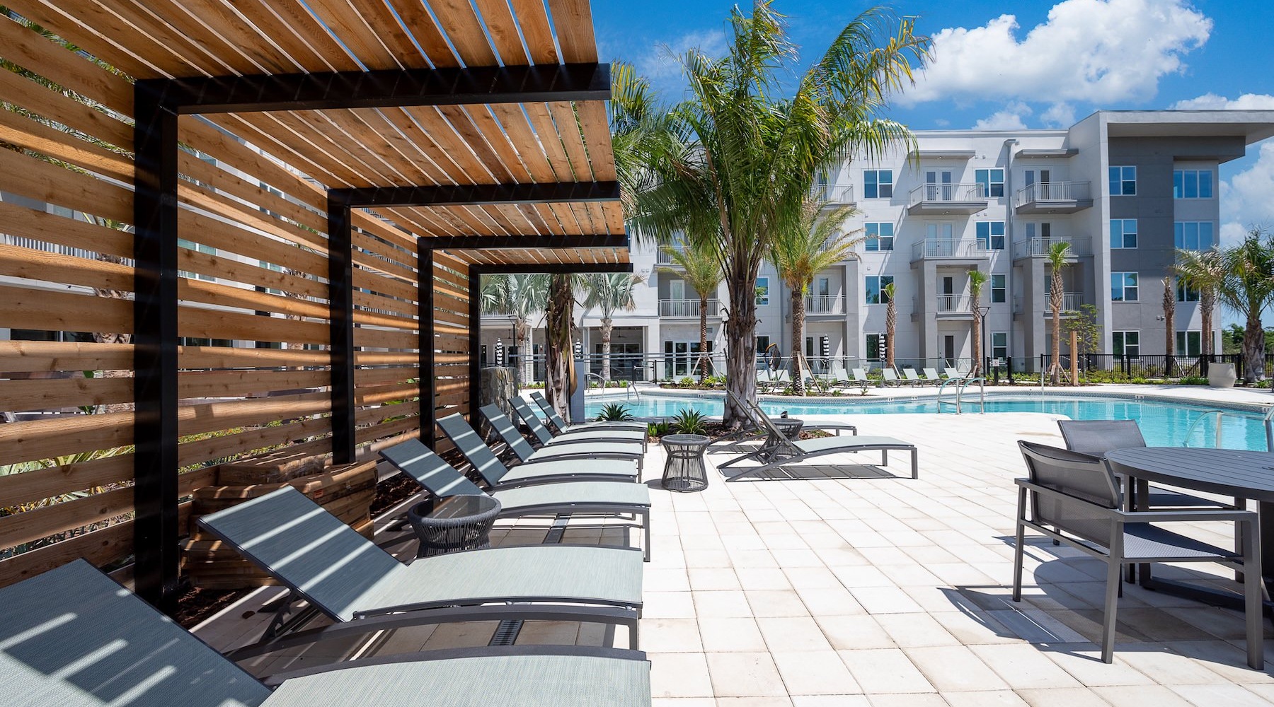 a swimming pool with lounge chairs
